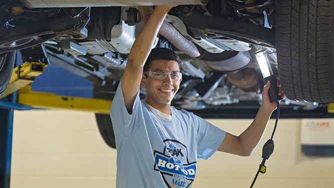 MATC Student working on the underside of a lifted car