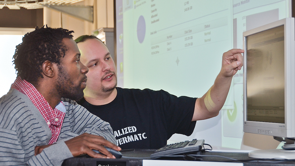 two students at computer screen