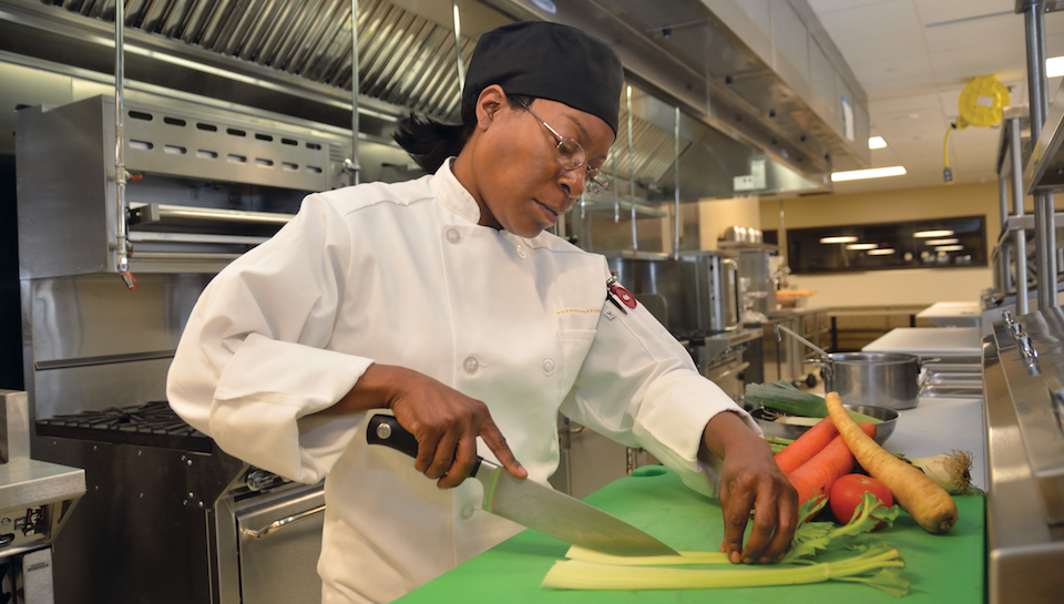 student cutting vegetables