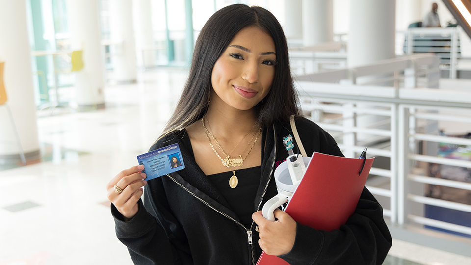 new student with her Stormer ID card and swag bag