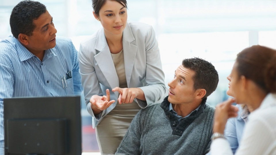 Young business woman explaining a project to colleagues