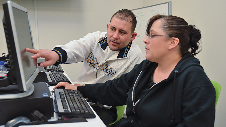 two student at a computer