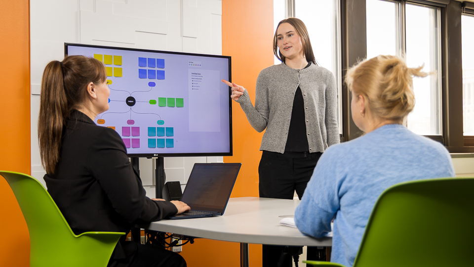 Marketing photo with three people in an office