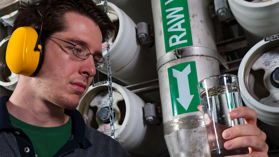 man inspecting a water sample