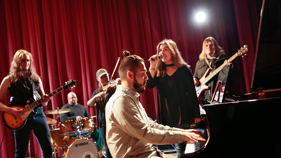 students performing on stage