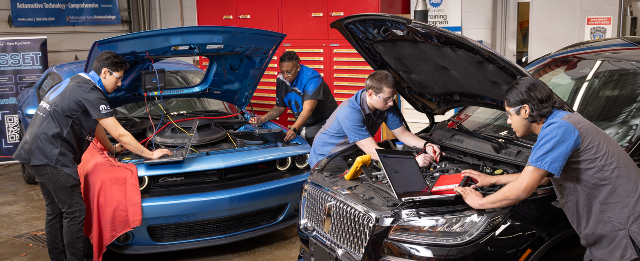 techs working on a car