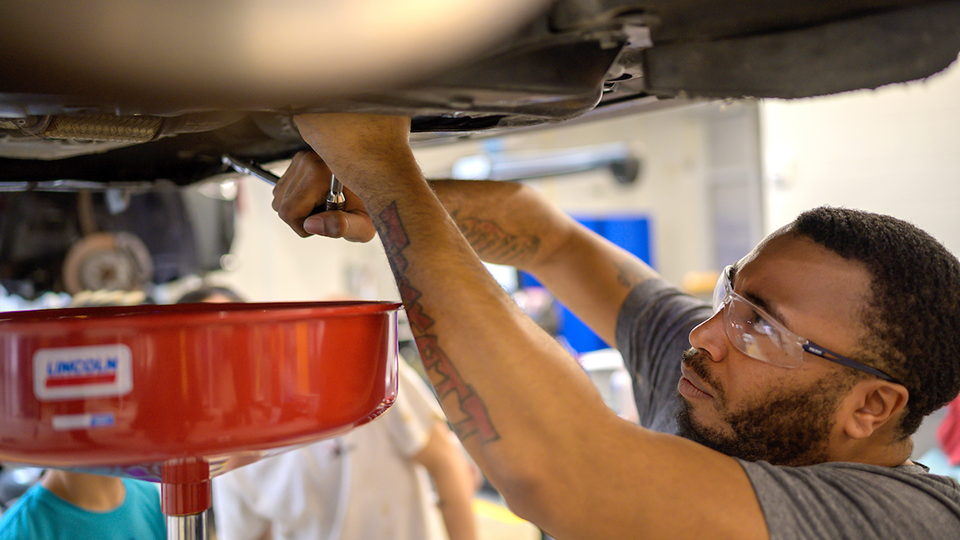 man working on lifted car
