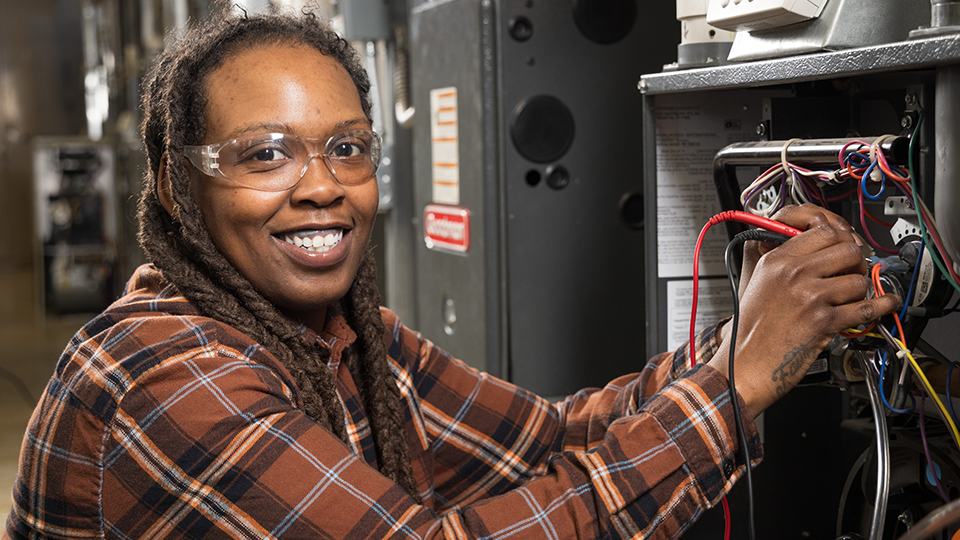 Woman working on HVAC unit