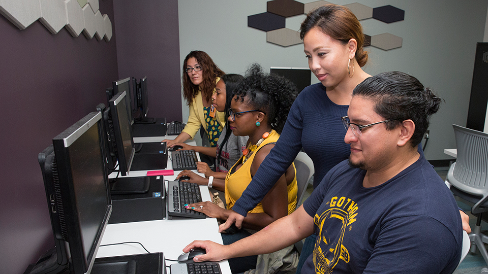 students receiving guidance at computers