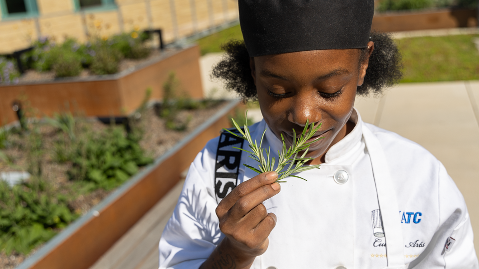 Student looking at freshly cut herbs
