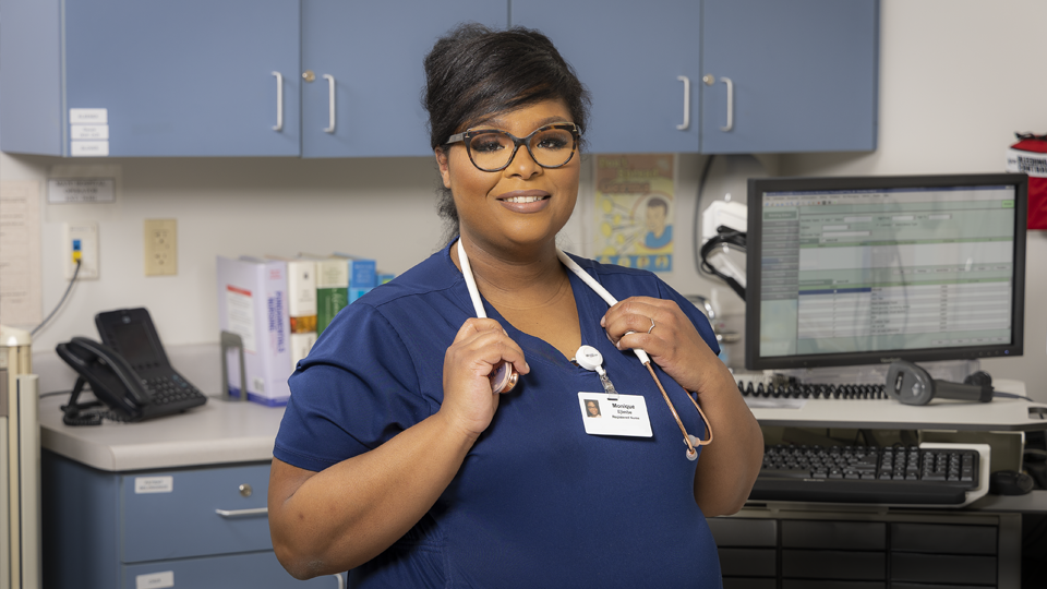 Monique Stewart Ejimbe with a stethoscope in a medical office