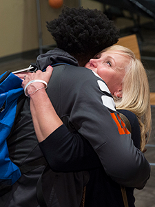 Kristin Kellerman hugs MATC basketball player Jarreyon Johnson.