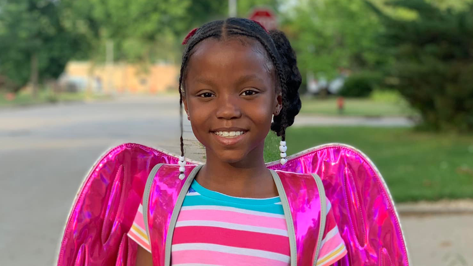 Young girl wearing an Angel backpack