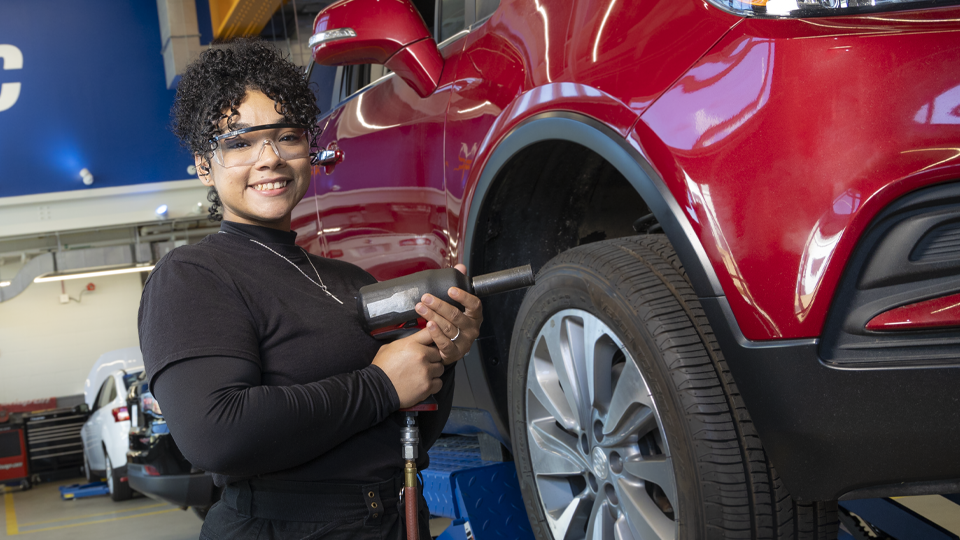 Samantha Albert goes to work fixing a car in the shop