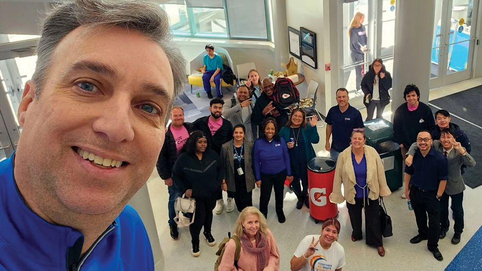 Anthony Cruz taking pictures with students