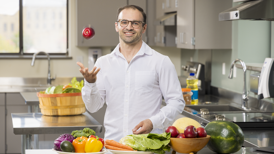Troy throwing an apple in the air